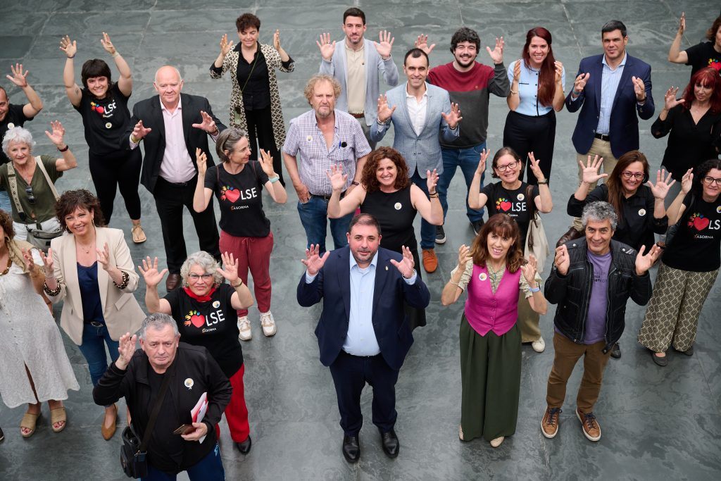 Parlamentarios y parlamentarias y miembros de ASORNA celebrando el Día Nacional de las Lenguas de Signos Españolas en el Parlamento de Navarra. Fotografía de grupo
