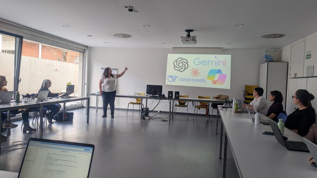 docente impartiendo el taller con la pantalla de su presentación personas alrededor en mesas.
